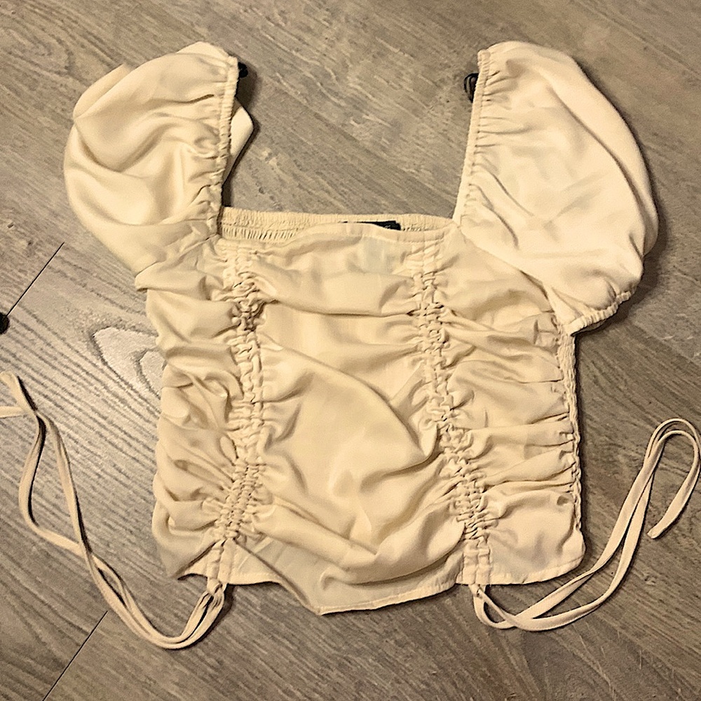The top is from forever 21. It is an a size small. The color is light brown.
